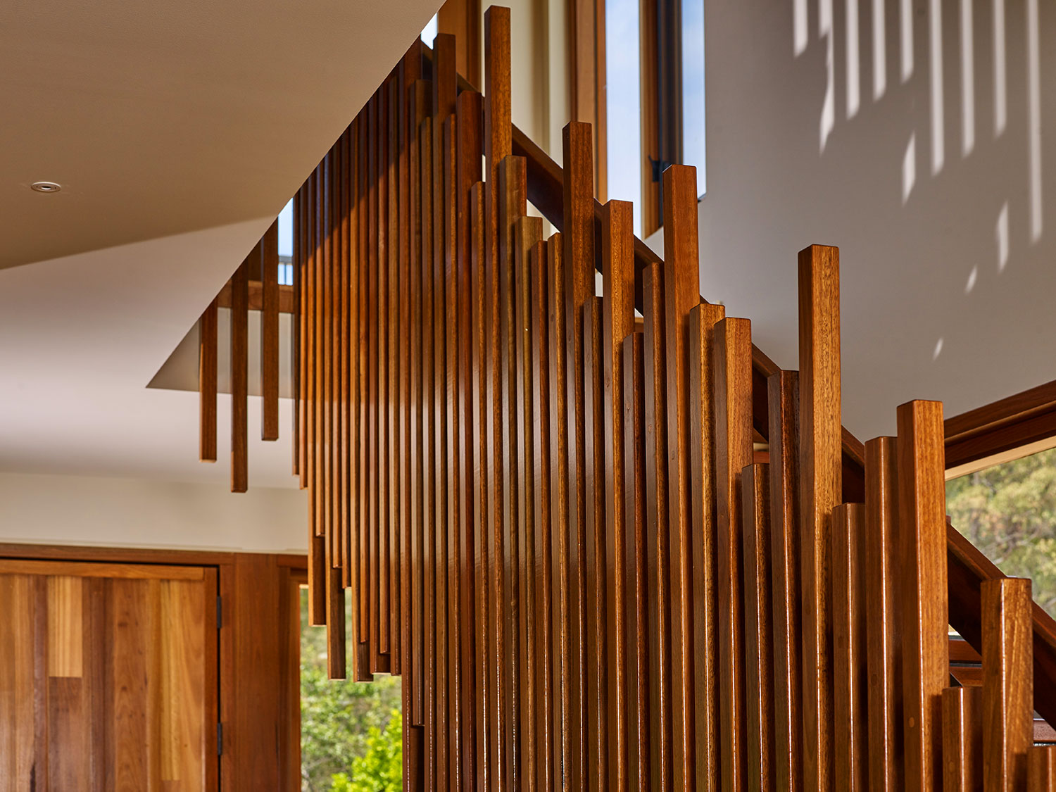 The home's balustrade is similar in feel to the timber matchstick-layering effect of Canberra’s Ovolo Hotel entry